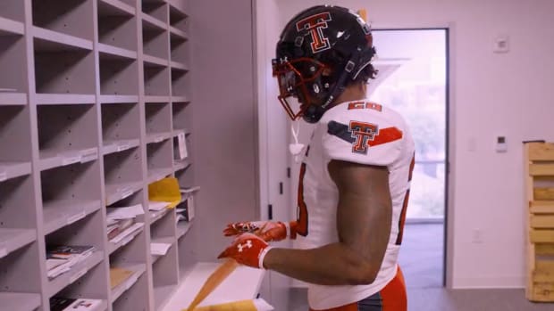 Screenshot of Texas Tech running back Tahj Brooks sorting mail.